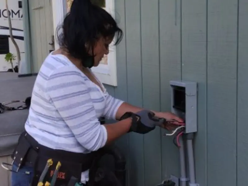 Licensed electrician wiring an exterior subpanel in Old Stine
