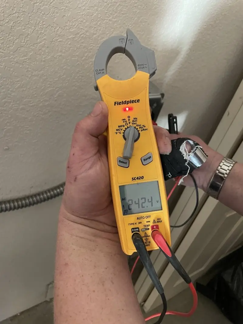 Voltage testing with clamp meter during Electrical Installation Services in Old Stine
